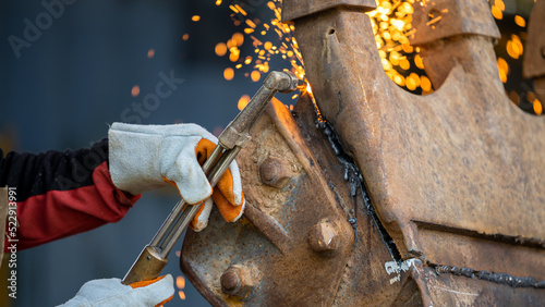 Industrial worker metal cutting with acetylene torch at factory welding steel structure, Welder is welding metalwork manufacturing construction maintenance service.