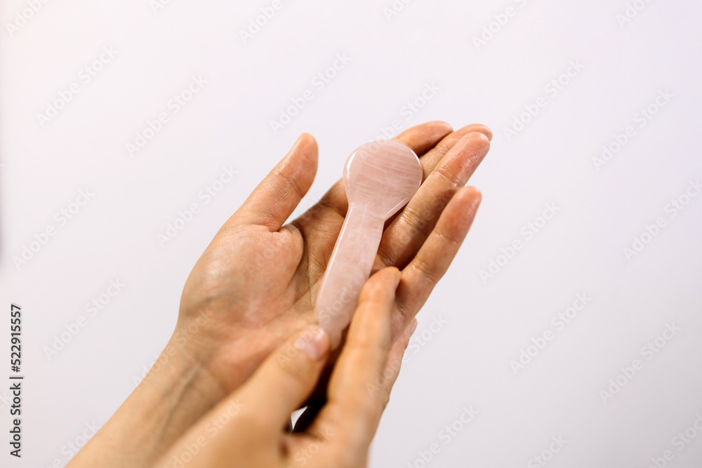 Gua sha tool in woman hands.
Beauty and skincare concept. Massage for facial lifting Gua sha tool in woman hands.
Beauty and skincare concept. Massage for facial lifting