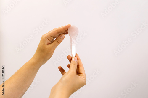 Gua sha tool in woman hands.
Beauty and skincare concept. Massage for facial lifting