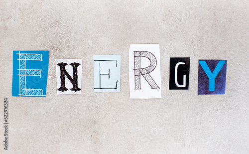 Energy, written with lettering from magazine clippings on mottled grey photo