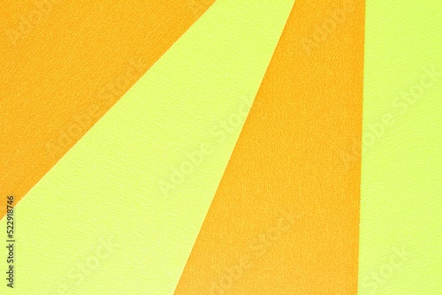 Abstract creative texture geometric pattern craft paper background. Yellow and orange colors. Structure design cardboard poster shape backdrop. Top view with copy space for text, flat lay, close-up