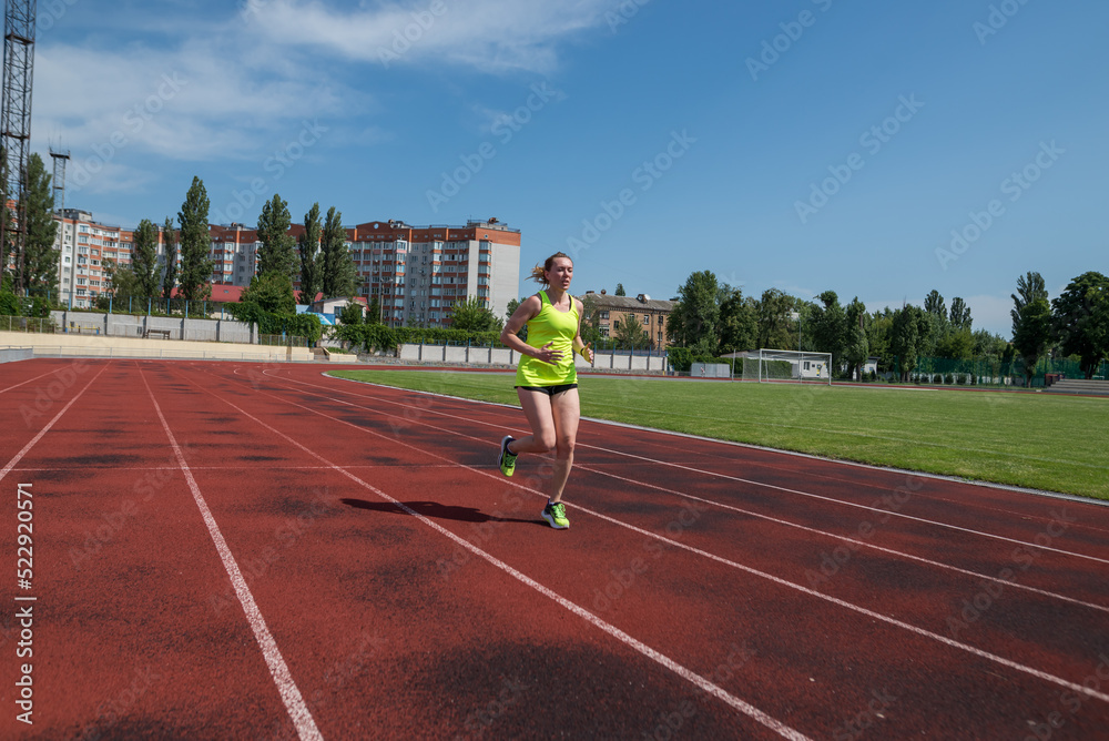 woman runs in the stadium. woman runs in the stadium.