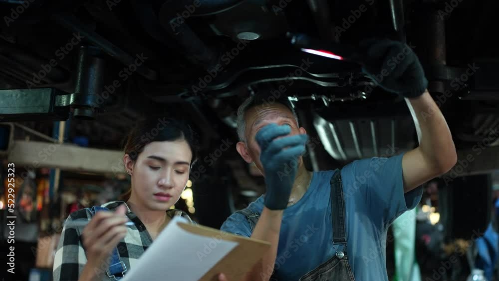 mechanic technician checking repair list for maintenance in automobile garage, inspection of automotive transportation service industry for vehicle, work of car engine workshop in auto motor station mechanic technician checking repair list for maintenance in automobile garage, inspection of automotive transportation service industry for vehicle, work of car engine workshop in auto motor station