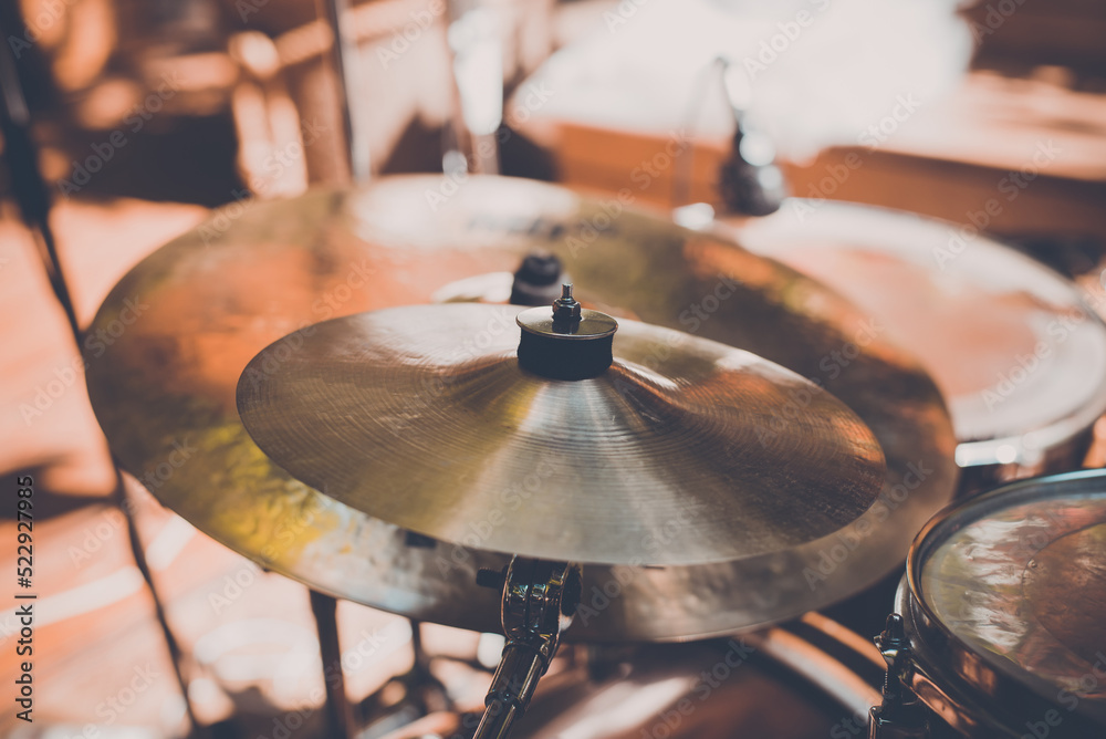 Obraz premium Drum kit at concert, hi-hat cymbals at street music festival on sunny day. Close-up, selective focus, toned image