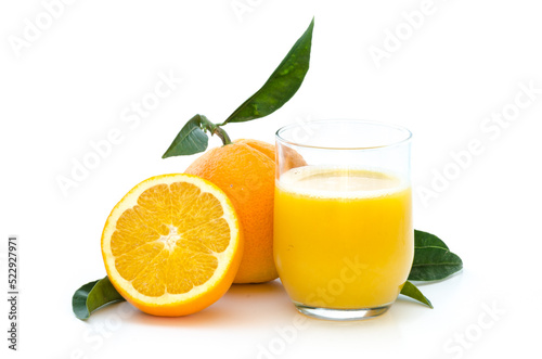 Oranges with fresh juice in a glass with leafs and stem on white background