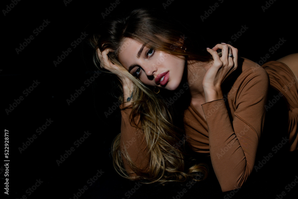 Sensual woman. Nice fit slim attractive tender sweet romantic girl lying on black bad. Portrait of a charming sexy sensual beautiful woman.