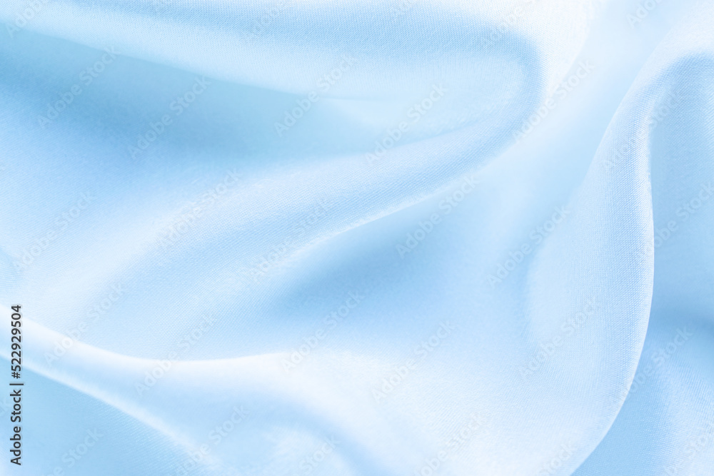 blue silk texture. background of blue fabric lying folds on the table blue silk texture. background of blue fabric lying folds on the table