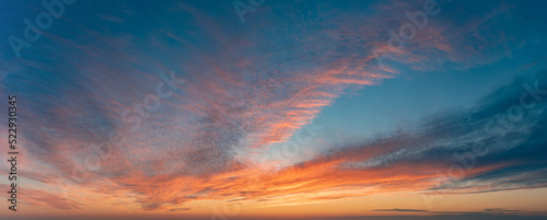 Widescreen Panorama Of The Sunset Sky After The Sun Has Gone Below The Horizon. Only The Sky Above The Horizon. Cirrus Low Clouds. Dramatic Sunset.