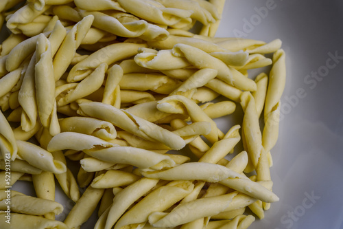 raw strozzapreti, specialties from northern Italy, fresh twisted pasta that cooks very quickly and is suitable for chunky sauces