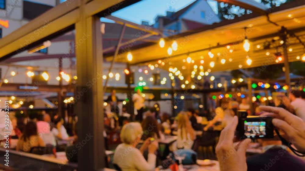 Defocused: Happy people dancing and partying at concert at night
