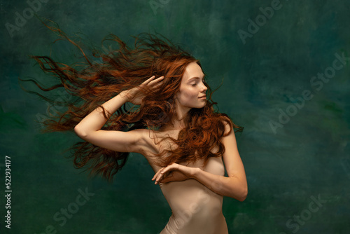 Принти на полотні Adorable tender redhead girl with long curly hair isolated over dark green background