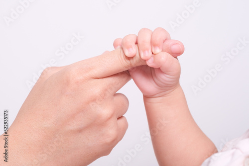 Soft focus of baby hands and mom, New family and baby protection love happy family concept.