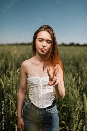 Beautiful girl posing in wheat field. Emotions of a girl