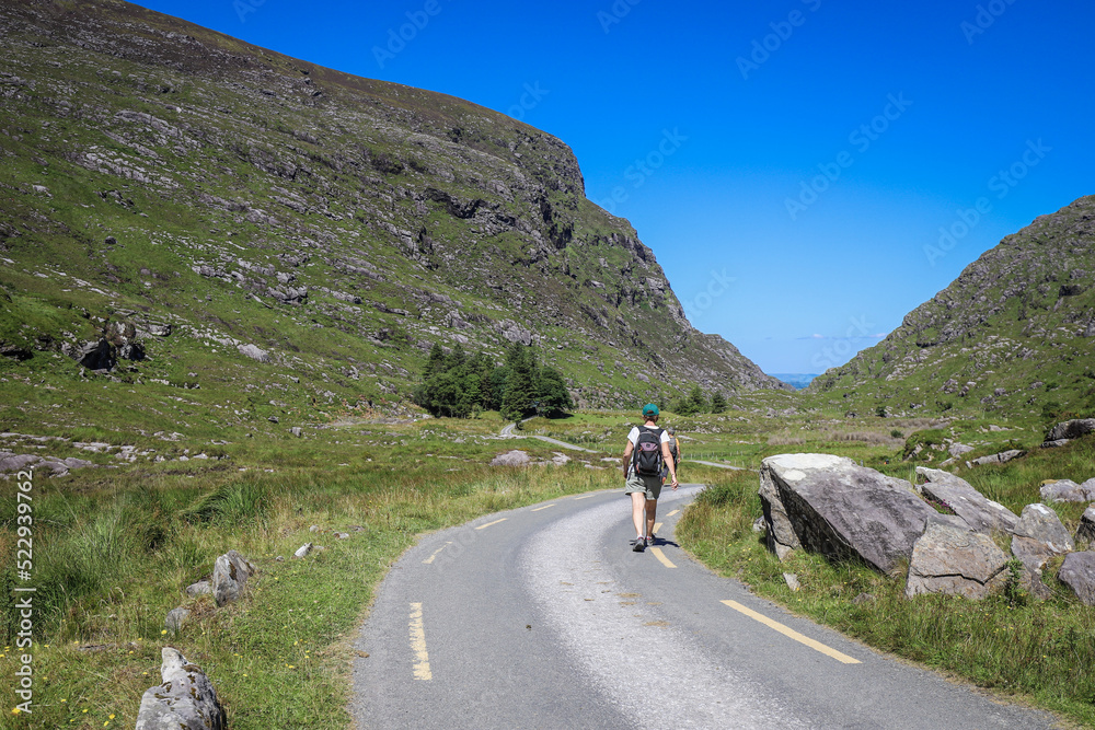 People trekking at The Gap of Dunloe, a narrow mountain pass running north south in County Kerry, Ireland