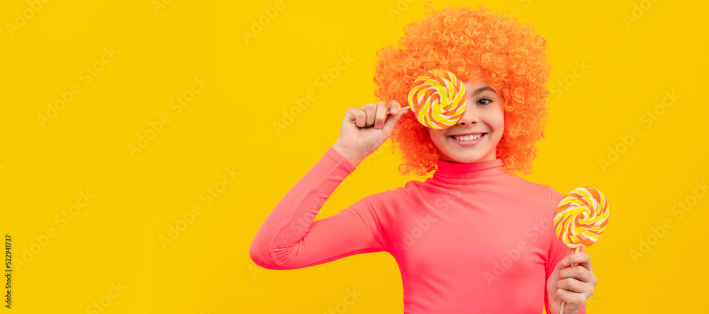 Happy girl child with orange hair in pink poloneck have fun holding lollipops, girlhood. Funny teenager child on party, poster banner header with copy space.