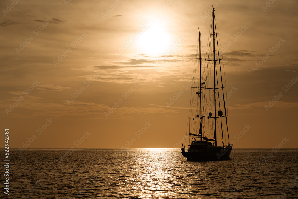 Silhouette of ship sailing on andaman sea at phuket, Thailand