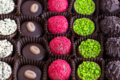 Packed chocolate. Assortment of packed truffle chocolates on a white background. close up