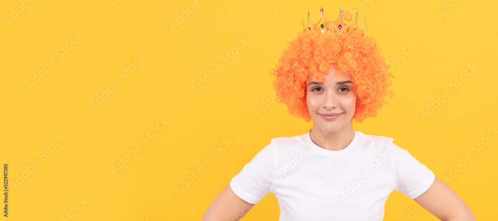 Party fun wig. cheeful freaky selfish woman in curly clown wig and queen crown for party, joy. Woman isolated face portrait, banner with copy space. Party fun wig. cheeful freaky selfish woman in curly clown wig and queen crown for party, joy. Woman isolated face portrait, banner with copy space.
