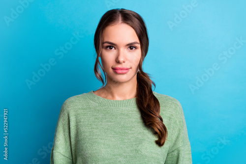 Photo of pretty calm young person look camera nice tail hairdo isolated on blue color background