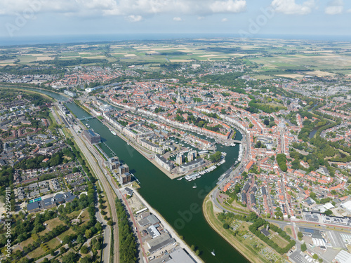 Middelburg is the capital city in the Dutch province of Zeeland on the former island Walcheren. urban skyline and city overview. Aerial drone overview of old city center canals and cultural heritage.
