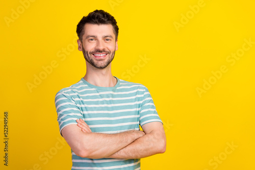 Portrait photo of young confident attractive guy hands crossed looking you recommend ad isolated on yellow color background