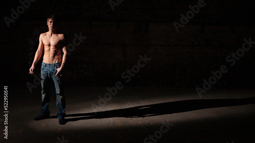 Shadowplay. Series of images of casually dressed models in a dark and industrial setting experimenting with light.