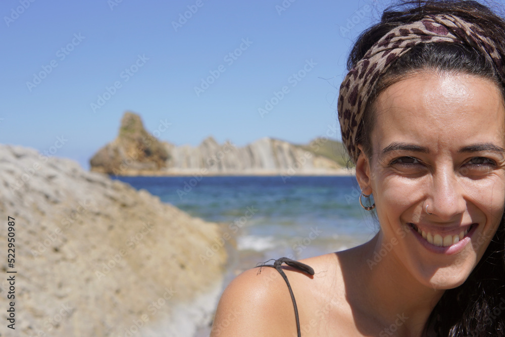 portrait of a woman with a coastal and rocky landscape behind in Costa Quebrada, Liencres portrait of a woman with a coastal and rocky landscape behind in Costa Quebrada, Liencres