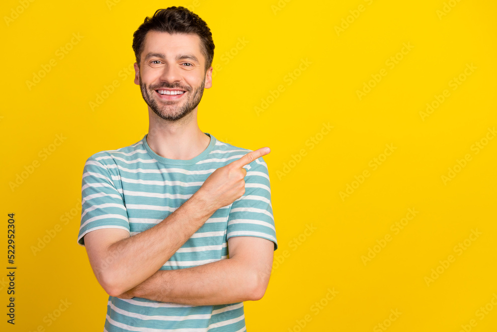 Portrait of young attractive smiling beaming guy pointing empty space good dentistry clinic isolated on yellow color background Portrait of young attractive smiling beaming guy pointing empty space good dentistry clinic isolated on yellow color background