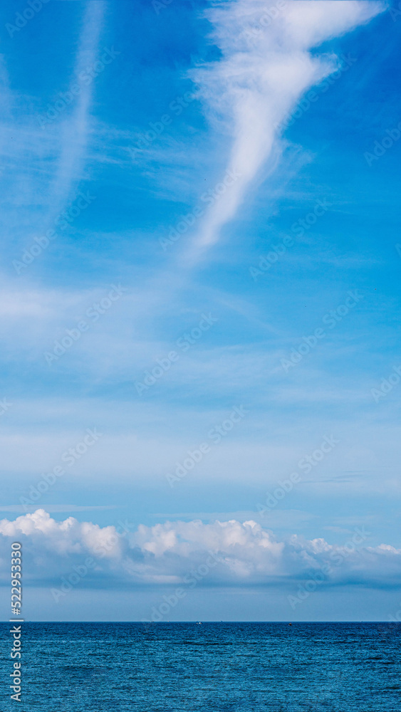 Atmosphere VERTICAL panorama real photo beauty nature wallpaper. Fantastic sky view clouds cumulus cirrus stratus sea horizon line. Wallpaper design background like painted fairy tale mood