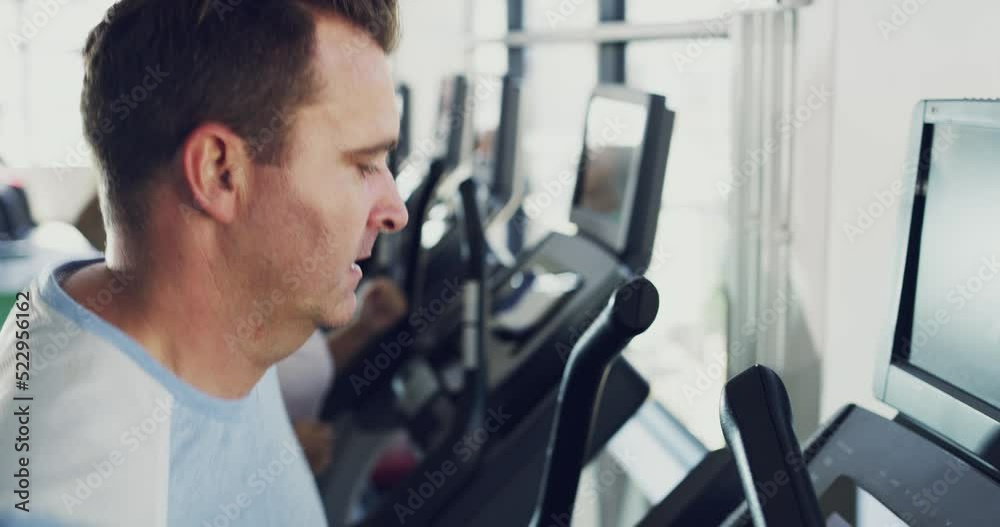 Male beginner jogging or running on treadmill, working on health and fitness in the gym. Normal person doing a workout, getting active and improving wellness. Man changing lifestyle and doing a detox Male beginner jogging or running on treadmill, working on health and fitness in the gym. Normal person doing a workout, getting active and improving wellness. Man changing lifestyle and doing a detox