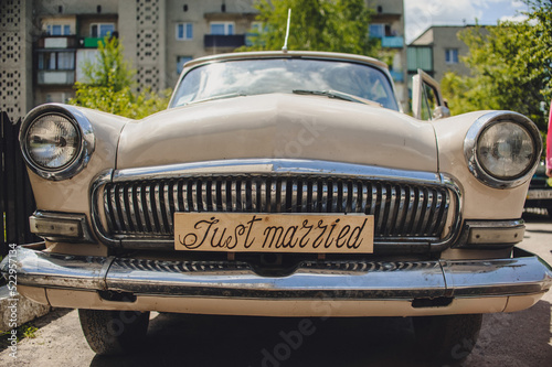 Car with just married sign in a blackboard. Antique wedding car.