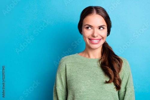 Photo of cheerful pretty lady beaming smile look interested empty space isolated on blue color background