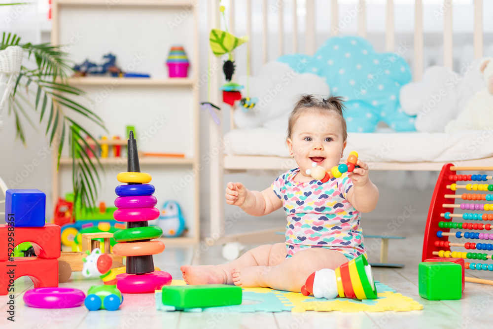 happy baby playing at home or in kindergarten. Toys for small children. early development happy baby playing at home or in kindergarten. Toys for small children. early development