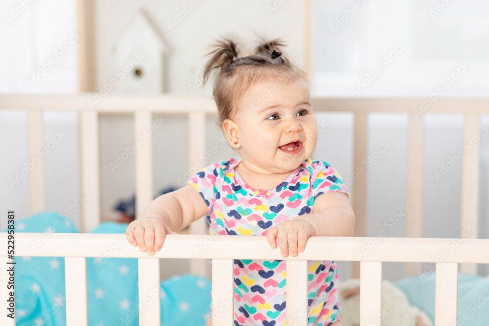 portrait of a baby in a crib, happy little baby at home portrait of a baby in a crib, happy little baby at home