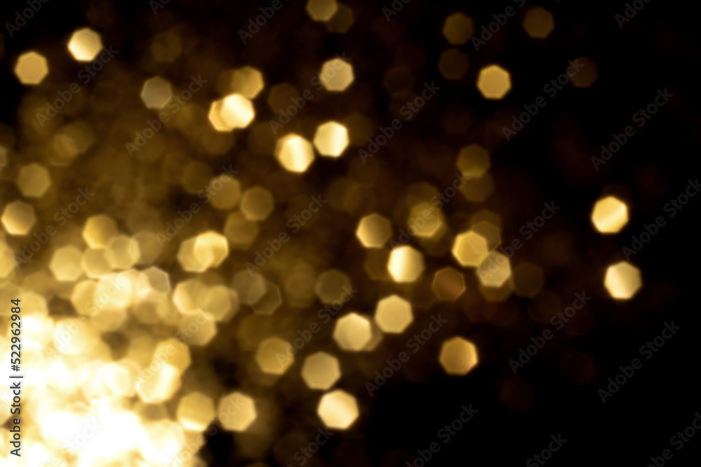 Golden blurred bokeh lights on black background. Glitter sparkle stars for celebrate. Overlay for your design Golden blurred bokeh lights on black background. Glitter sparkle stars for celebrate. Overlay for your design