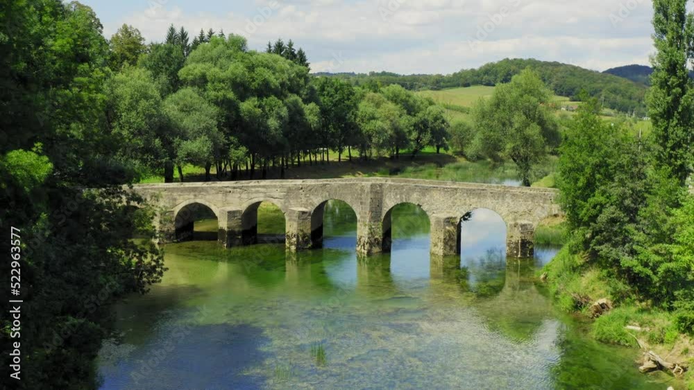 Aerial view of the old stone bridge on the Dobra River, Croatia Aerial view of the old stone bridge on the Dobra River, Croatia