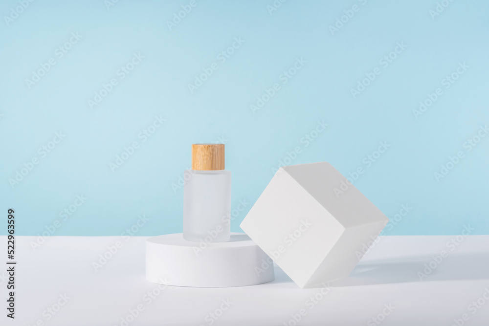 Cosmetic luxury cream tube bottle mockup on blue background on pedestal podium. Unbranded lotion beauty product packaging. Product presentation mock up. Lotion, mousse, cleanser for skincare routine