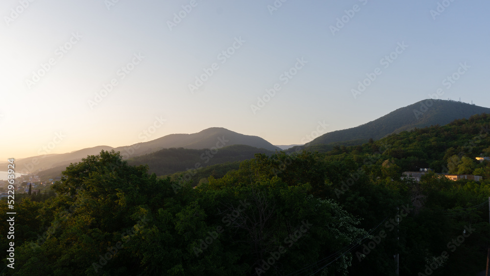 Panorama of sunset in the mountains. A magical view of the sea from the observation deck. Lazarevskoe, Sochi, Russia.