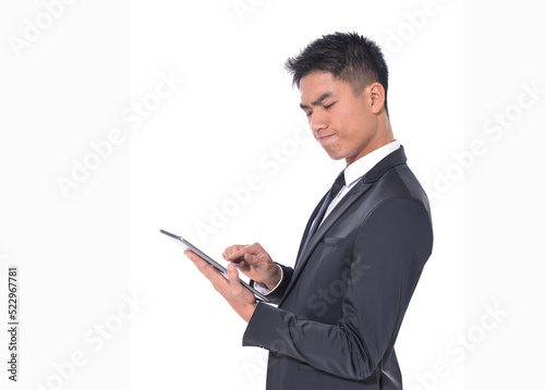 Handsome young business man
wear formal suit with black tie, using digital tablet, Businessman portrait Isolated on white background
