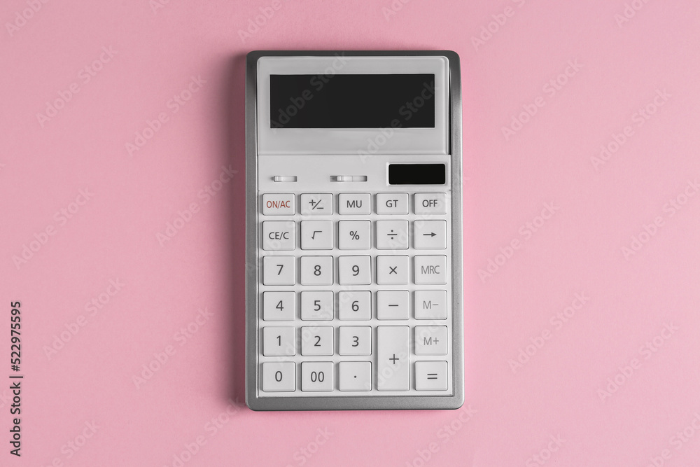 White calculator on pink background, top view White calculator on pink background, top view