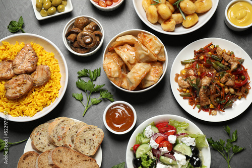 Buffet service. Many different dishes on grey table, flat lay