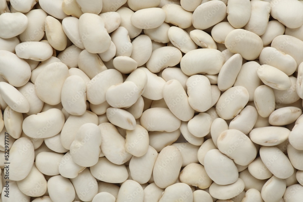 Pile of uncooked white beans as background, top view