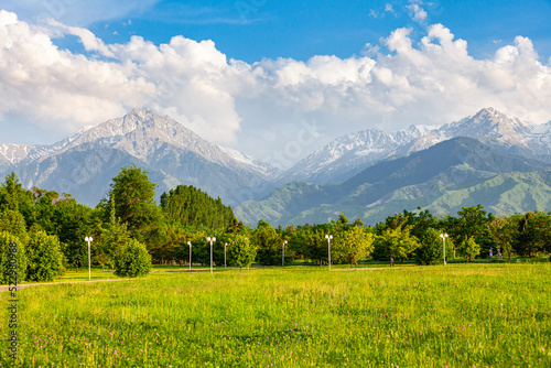 Obraz na płótnie a favorite resting place of Almaty residents in the park of the first president against the backdrop of the Tien Shan mountains. Summer time w salonie