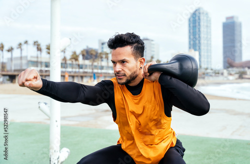 Young athlete training in the morning on the beach at the gym. outdoor. Representation of sport and healthy lifestyle concepts photo