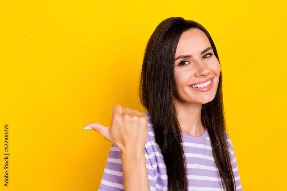Closeup photo of young cute perfect girl showing finger empty space cool spa salon for weekend isolated on yellow color background Closeup photo of young cute perfect girl showing finger empty space cool spa salon for weekend isolated on yellow color background