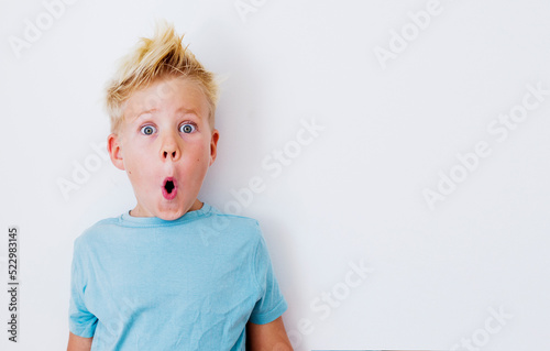 blondie cheerful 6 years old boy over white background