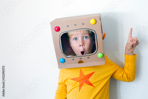 Caucasian Blondie boy over white background/boy in robot, astronaut creative costume