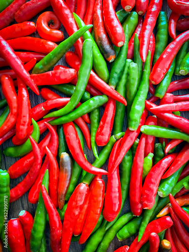 Fresh red chili and space for text on wooden background