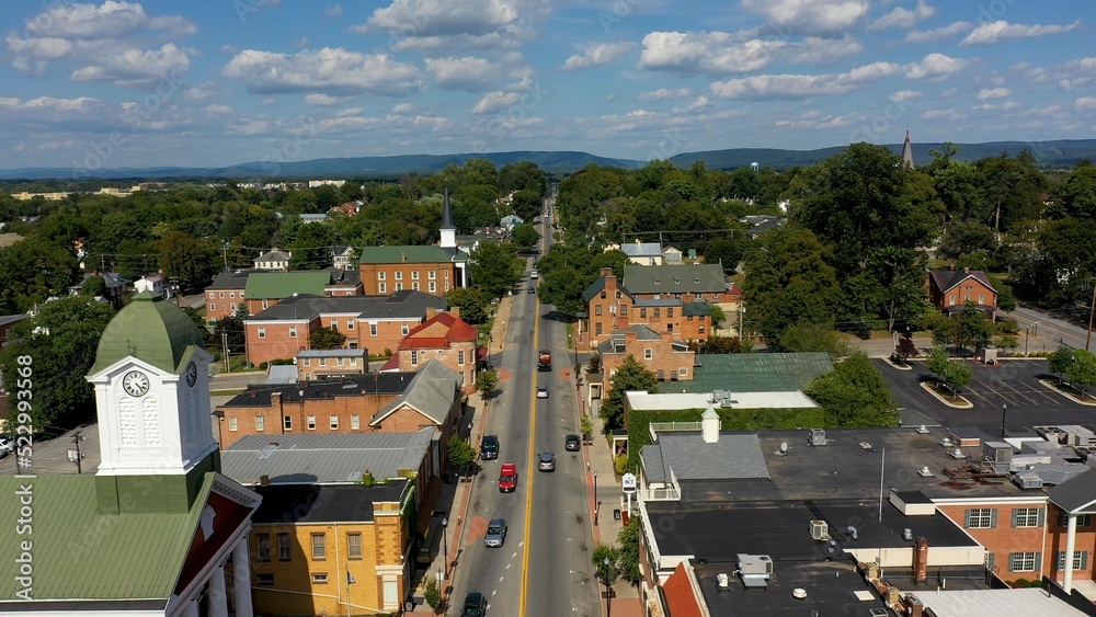 Fototapeta premium Low aerial view of main street usa, Charles Town, West Virginia, WV on a beautiful sunny day.