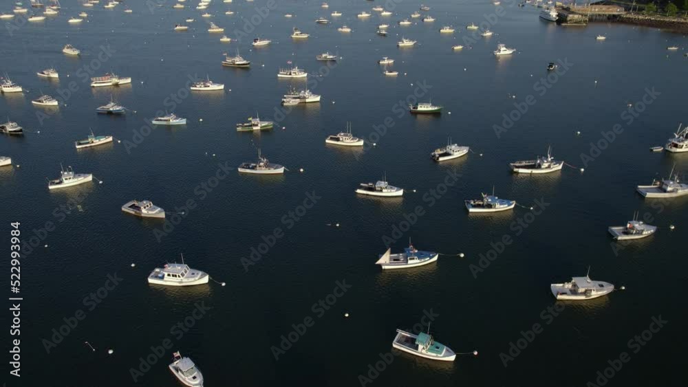 Aerial view over anchored boats on the coast of Plymouth, sunset in Massachusetts, USA - tilt, drone shot Aerial view over anchored boats on the coast of Plymouth, sunset in Massachusetts, USA - tilt, drone shot